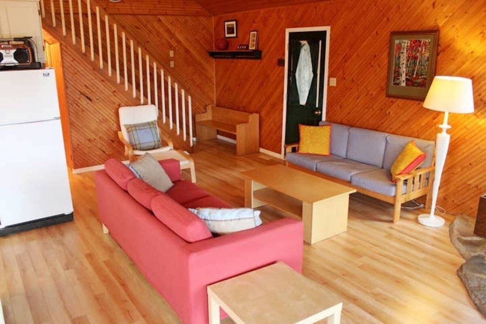 Open-concept living room with wood floors and a red sofa
